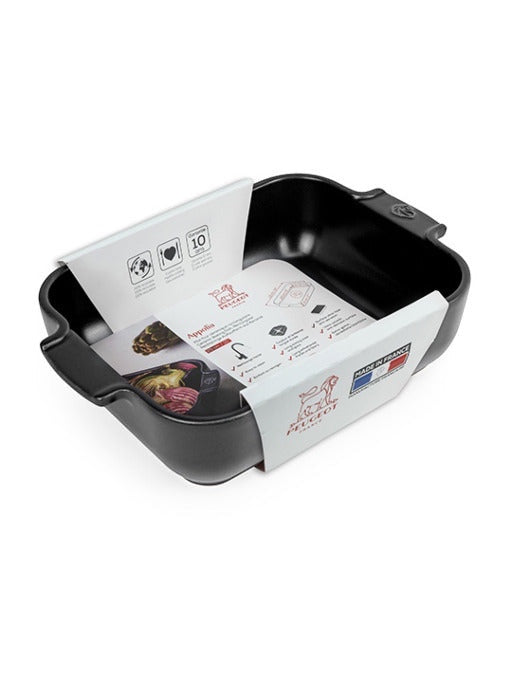 Eclectic Appolia rectangular ceramic oven dish in satin black with ribbed handles and product information packaging.