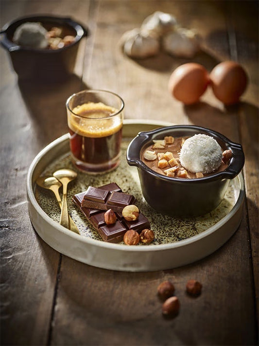 Eclectic Appolia satin black ceramic ramekin filled with chocolate dessert on a rustic wooden table with ingredients