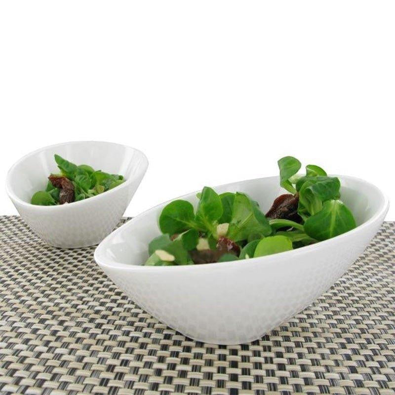 Eclectic ASA Selection ivory white porcelain bowls with an asymmetric slanted design filled with fresh green salad