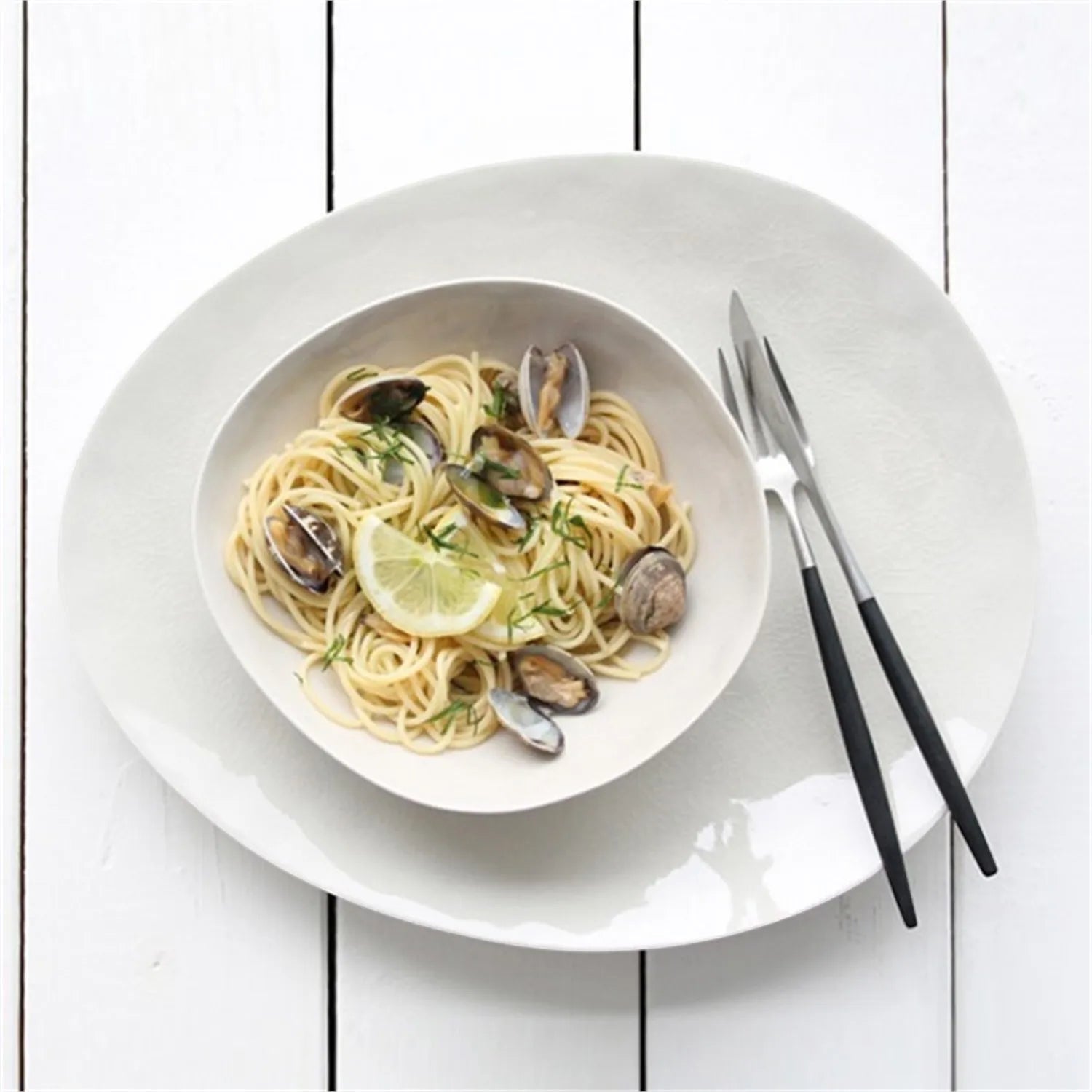 Eclectic ASA Selection À La Maison champagne ceramic stoneware bowl with craquelure glaze holding pasta on a white table