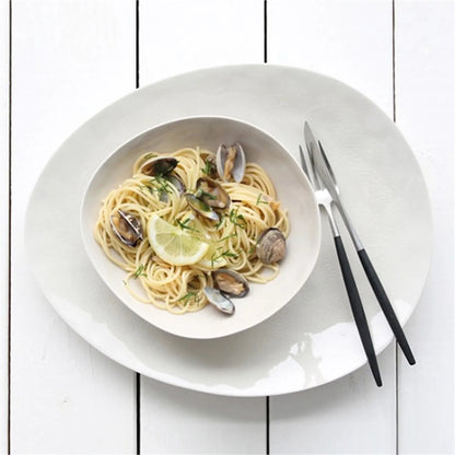 Eclectic ASA Selection À La Maison champagne ceramic stoneware bowl with craquelure glaze holding pasta on a white table