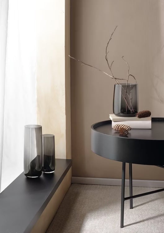 Eclectic ASA Selection Ajana smoky grey mouth-blown glass vases styled as candle holders on a modern table and ledge.