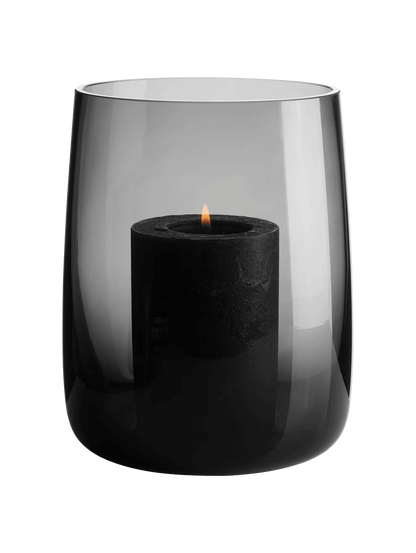 Eclectic ASA Selection Ajana smoky grey mouth-blown glass vase and candle holder with a lit black pillar candle.