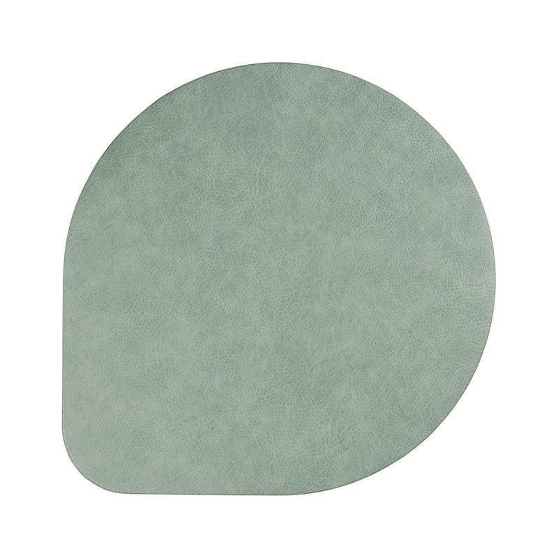 Eclectic ASA Selection spearmint vegan leather placemat with a soft matte finish and organic shape