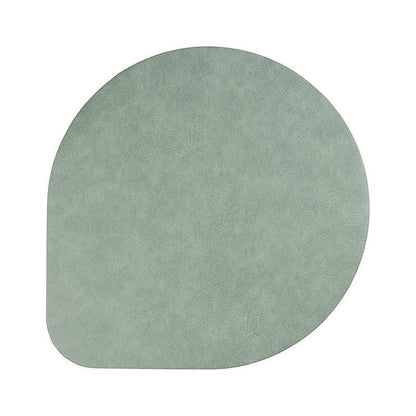 Eclectic ASA Selection spearmint vegan leather placemat with a soft matte finish and organic shape