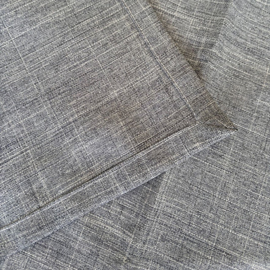 Eclectic ash grey linen-look polyester table runner with a detailed view of the woven fabric texture and stitched hem.