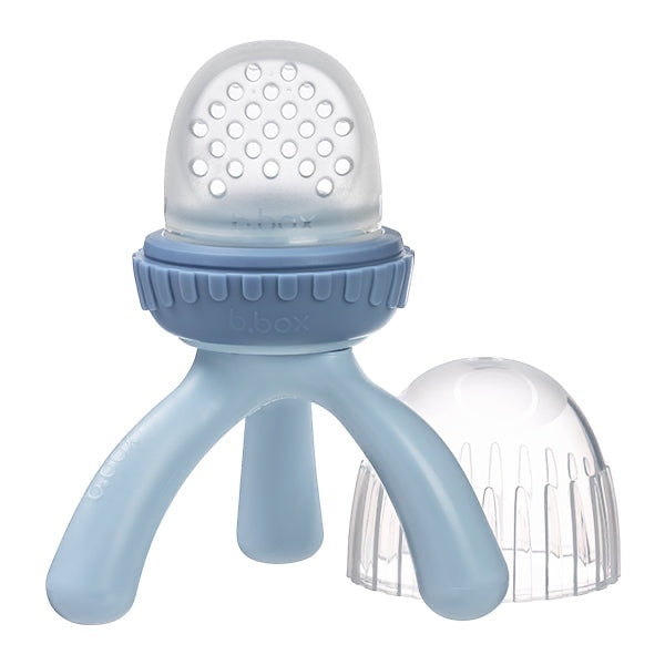 Eclectic B.Box blue silicone fresh food feeder with a tripod base and protective cap for safe baby self-feeding.