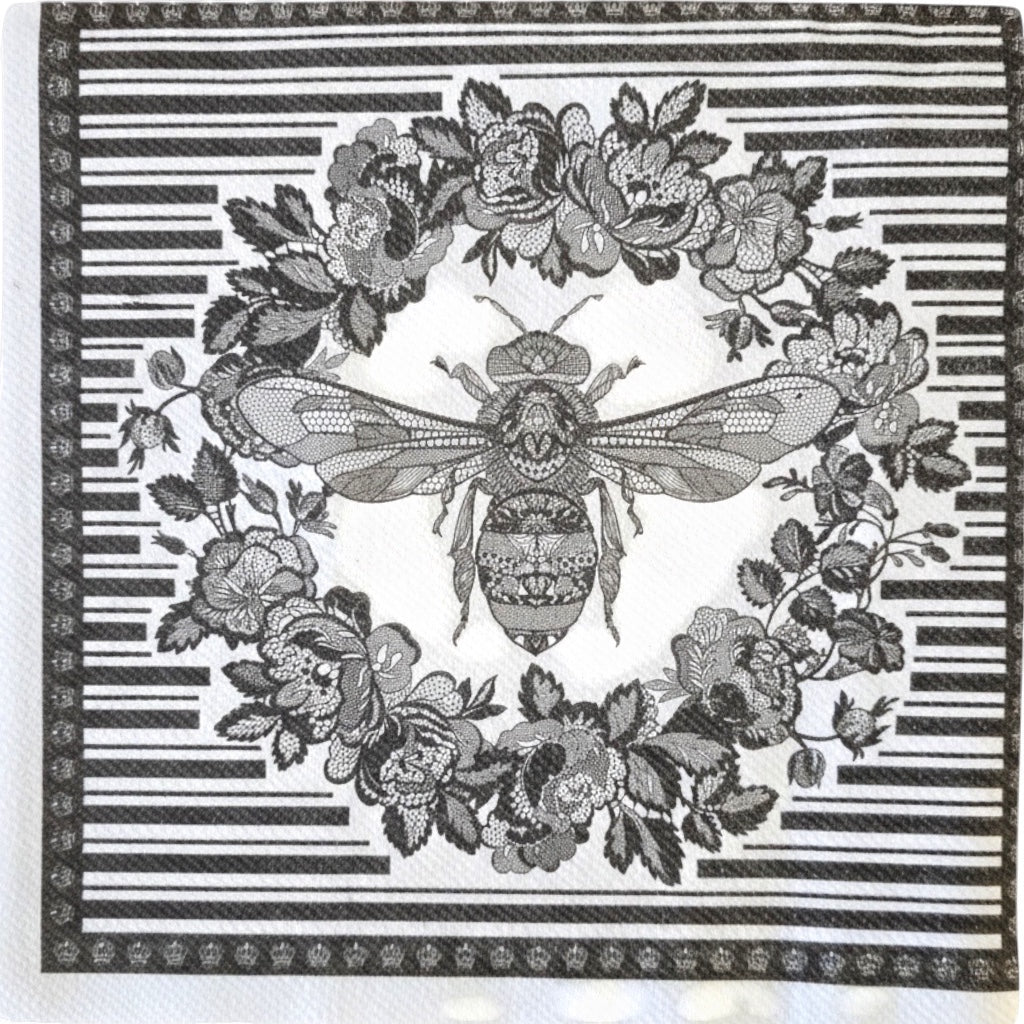 Eclectic Bee Black disposable napkin featuring an intricate bee and floral wreath motif with a graphic linear border.