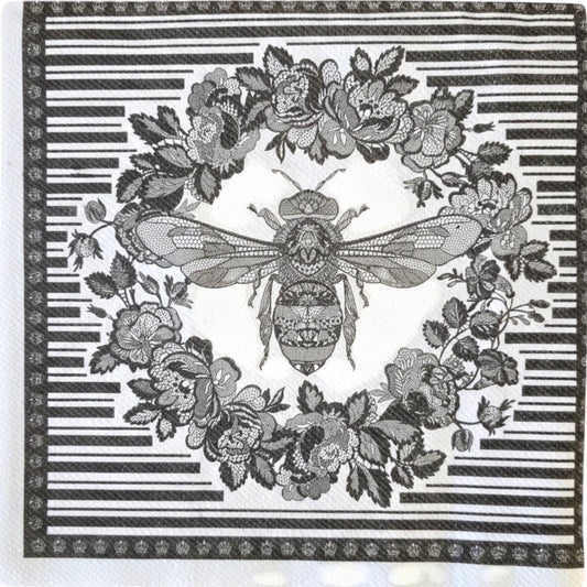 Eclectic Bee Black disposable napkin featuring an intricate bee and floral wreath motif with a graphic linear border.