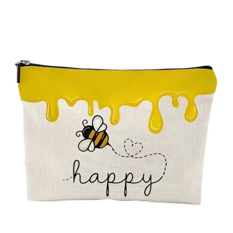 Eclectic Bee Happy makeup bag in cream canvas with yellow honey drip print and cute bee illustration