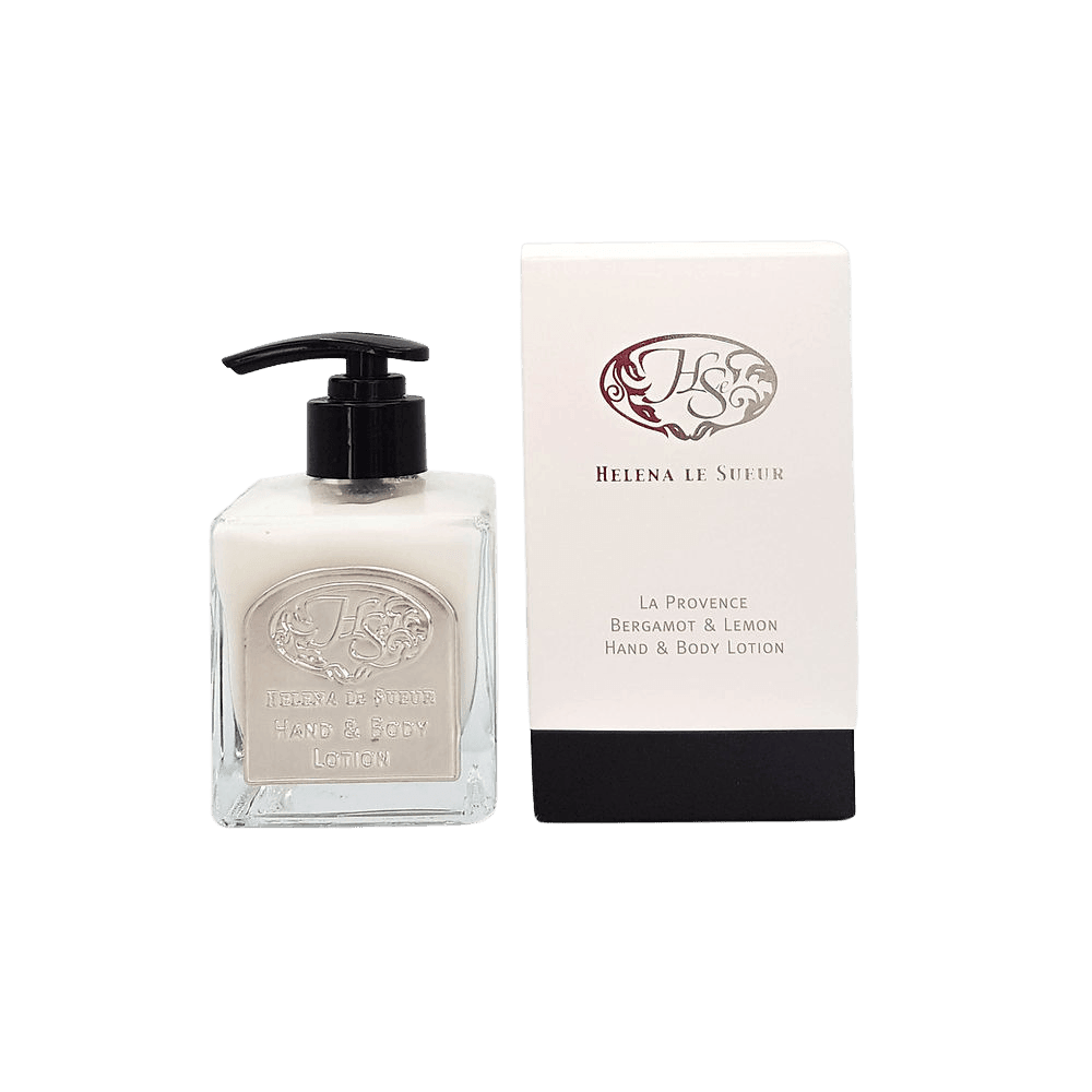 Eclectic Bergamot & Lemon hand and body lotion in a square glass pump bottle next to its elegant white and black box.