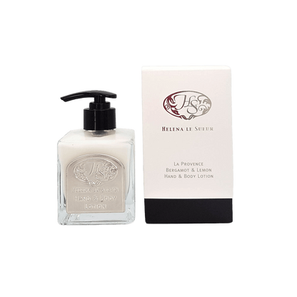 Eclectic Bergamot & Lemon hand and body lotion in a square glass pump bottle next to its elegant white and black box.