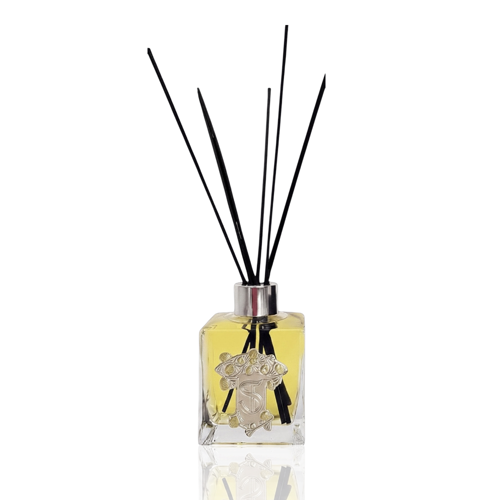 Eclectic Bergamot & Lemon reed diffuser in a square glass bottle with a pewter-style emblem and black reeds.