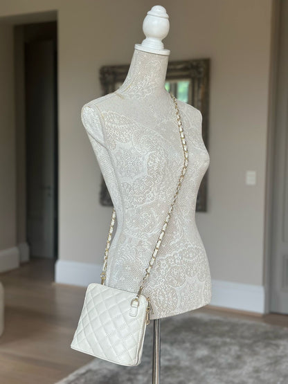 Eclectic Bianca cream quilted leather crossbody bag with gold-tone chain strap displayed on a mannequin