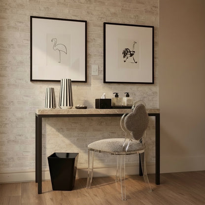 Eclectic black square tapered acrylic dustbin placed under a modern vanity table in a minimalist bedroom setting.