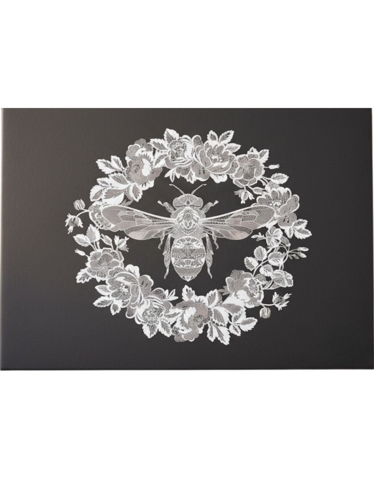 Eclectic black paper disposable placemat featuring an intricate white bee and floral wreath design.