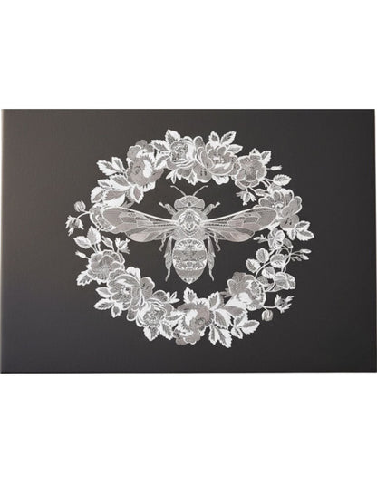 Eclectic black paper disposable placemat featuring an intricate white bee and floral wreath design.