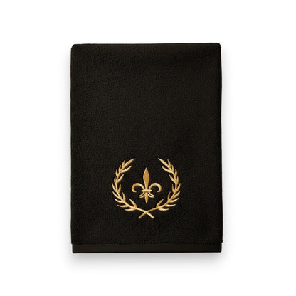 Eclectic black cotton guest towel with an elegant gold embroidered crown and laurel wreath design.
