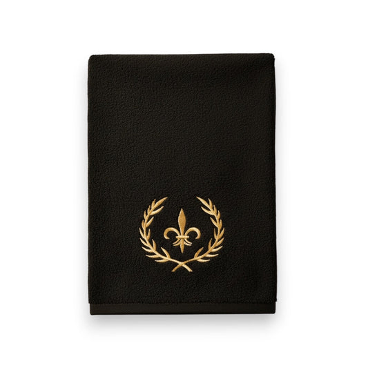 Eclectic black cotton guest towel with an elegant gold embroidered crown and laurel wreath design.