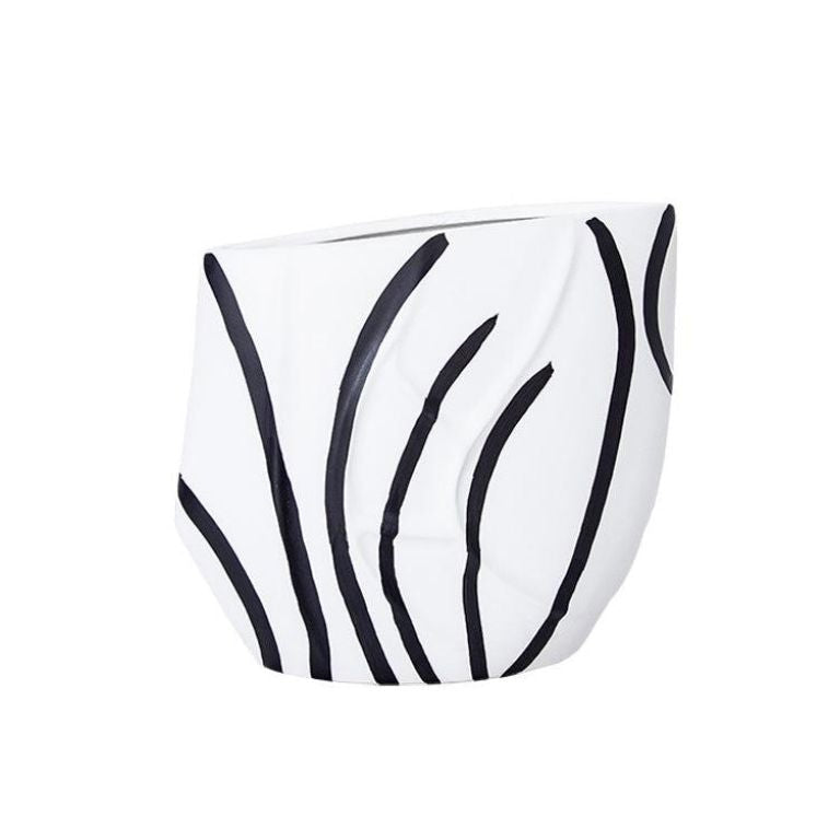Eclectic black and white ceramic vase with a curved silhouette and graphic reed-inspired pattern in a gloss finish.