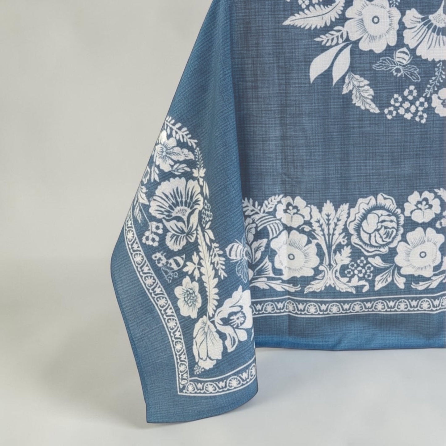 Eclectic soft blue floral tablecloth with a linen-look finish and detailed white botanical pattern