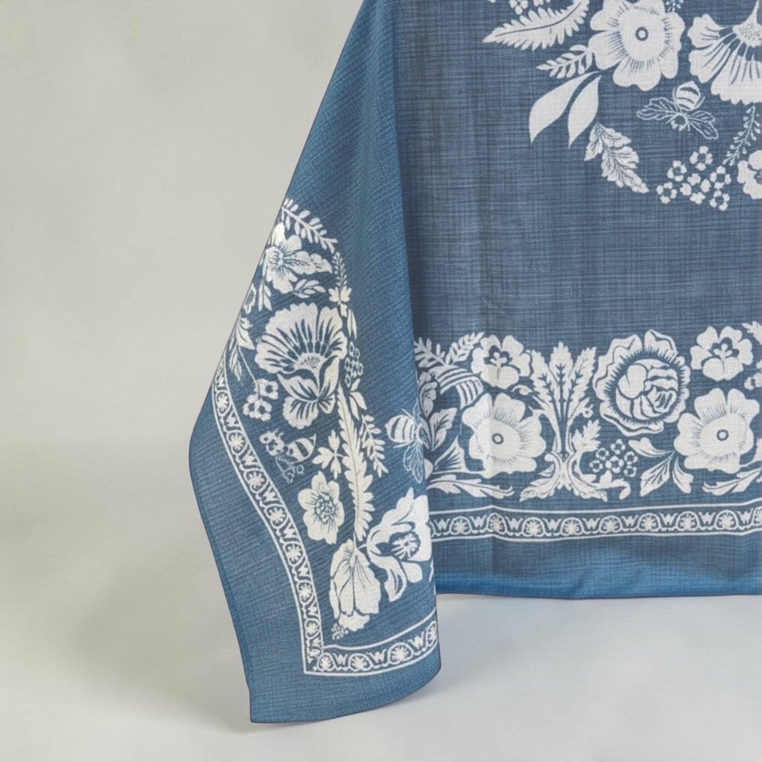 Eclectic soft blue floral tablecloth with a linen-look finish and detailed white botanical pattern