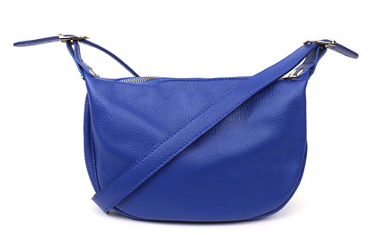 Eclectic blue grained leather half moon sling bag with an adjustable strap and a curved crescent silhouette.
