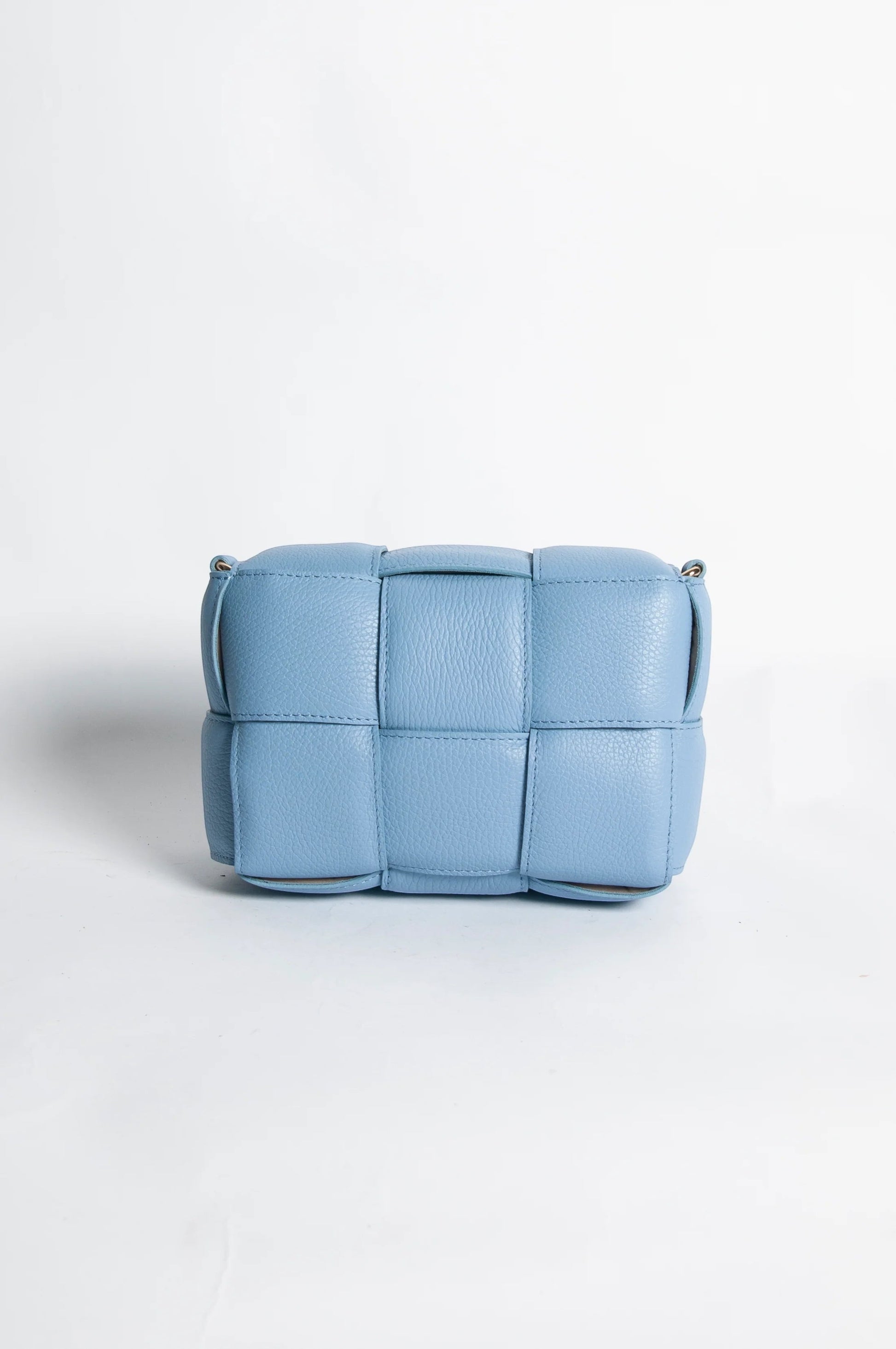Eclectic blue Aria quilted leather box crossbody bag with a padded woven texture and gold-tone hardware.