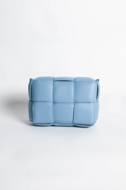 Eclectic blue Aria quilted leather box crossbody bag with a padded woven texture and gold-tone hardware.