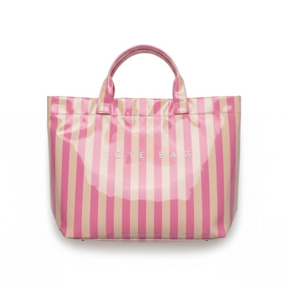 Eclectic blush and neutral striped PVC carry tote bag with fixed shoulder straps and magnetic closure.
