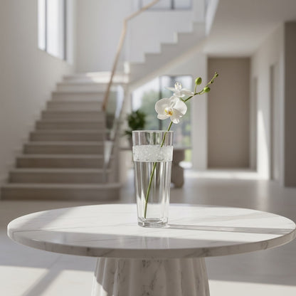 Eclectic Bohemia Aurora clear lead-free crystal vase with ornate band holding a white orchid on a marble table.