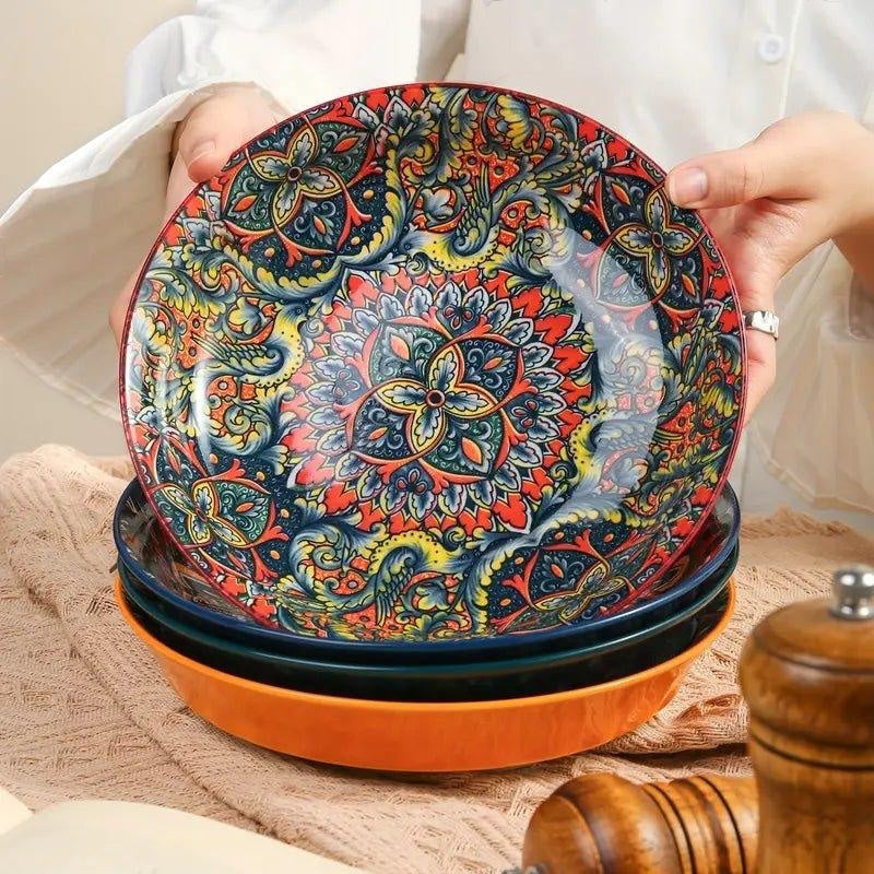 Eclectic bohemian red ceramic pasta bowl featuring an intricate, vibrant mandala pattern held by a person.