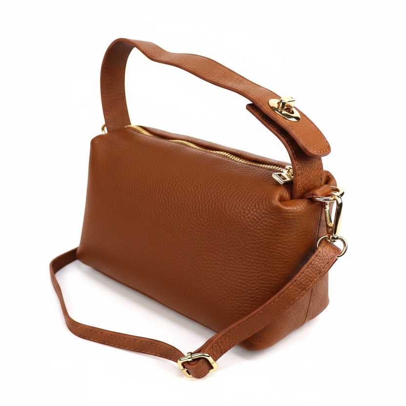 Eclectic brown pebbled leather top handle crossbody bag with gold-tone hardware and twist-lock detail.
