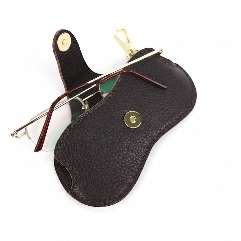 Eclectic brown leather glasses case with gold-tone snap button and clip, shown open with eyewear inside.