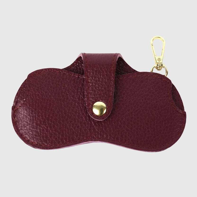 Eclectic burgundy leather glasses case with a gold-tone snap button and clip for attaching to bags.