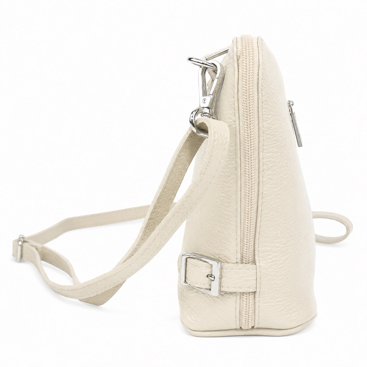 Eclectic Capri cream grained leather crossbody bag with silver hardware and side buckle detail, side view.