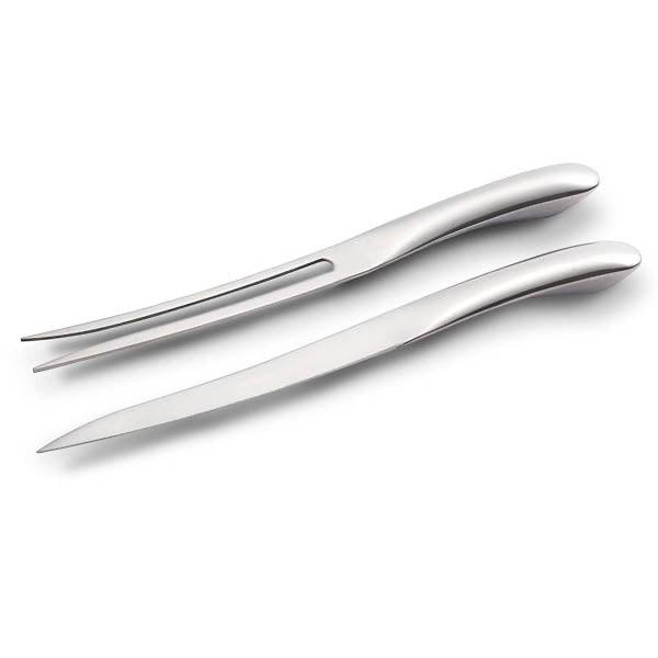 Eclectic Capri stainless steel slim carving knife and fork set with a sleek, modern silver finish.