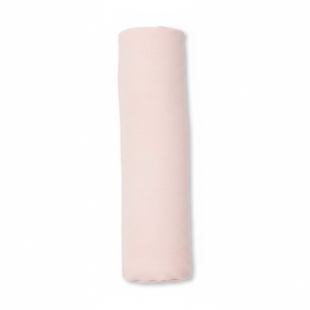Eclectic Carter’s blush pink cotton muslin baby swaddle blanket rolled up on a white background.