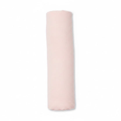 Eclectic Carter’s blush pink cotton muslin baby swaddle blanket rolled up on a white background.