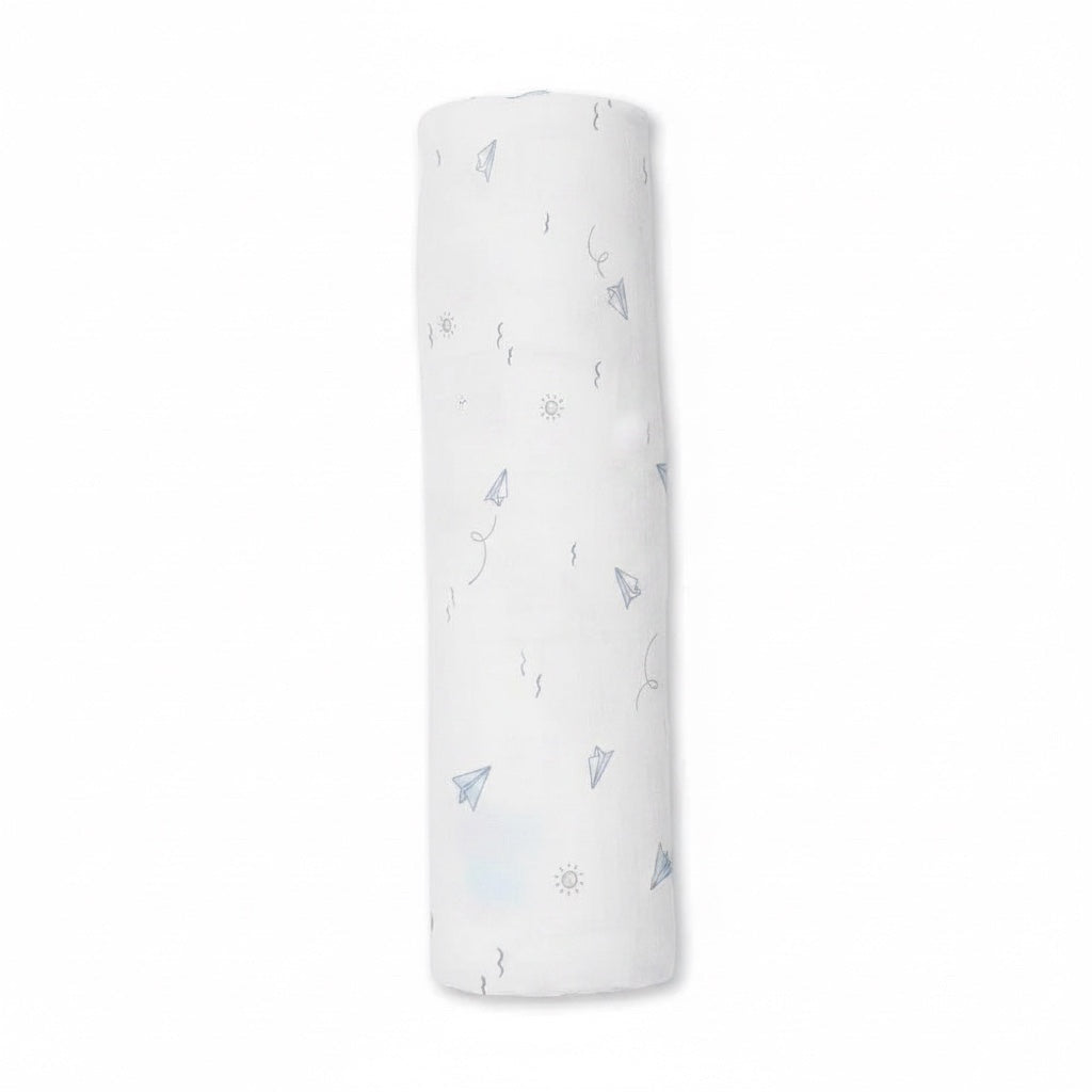 Eclectic Carter’s cotton muslin swaddle in white with blue paper plane and cloud print, rolled for display.