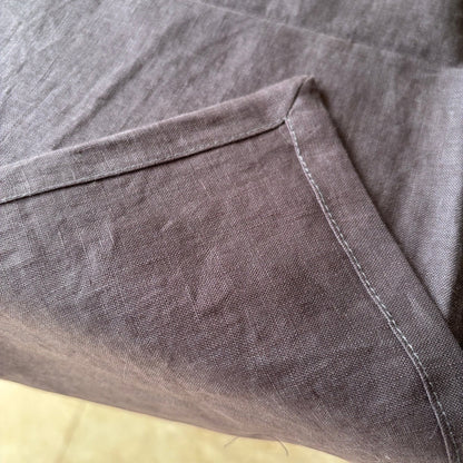 Eclectic charcoal 100% linen table runner with detailed stitched corner edging and natural fabric texture
