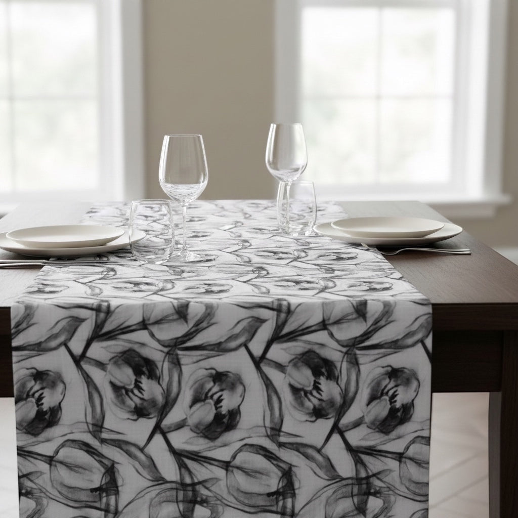 Eclectic charcoal tulip print polyslub tablecloth with a stain-resistant finish on a wooden dining table.