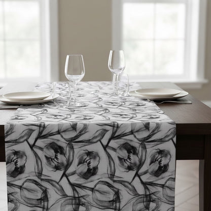 Eclectic charcoal tulip print polyslub tablecloth with a stain-resistant finish on a wooden dining table.