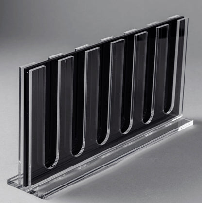 Eclectic clear acrylic espresso pod stand with a slim, double-sided design for 60 coffee capsules on a grey background.