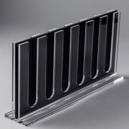 Eclectic clear acrylic espresso pod stand with a slim, double-sided design for 60 coffee capsules on a grey background.