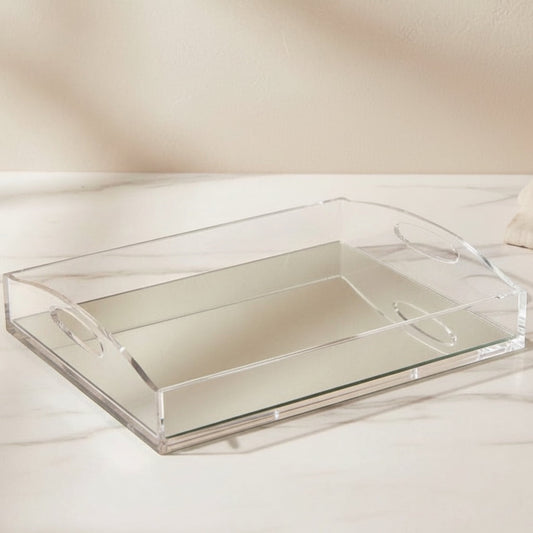 Eclectic clear acrylic gallery tray with a reflective mirrored base and integrated handles on a marble surface.