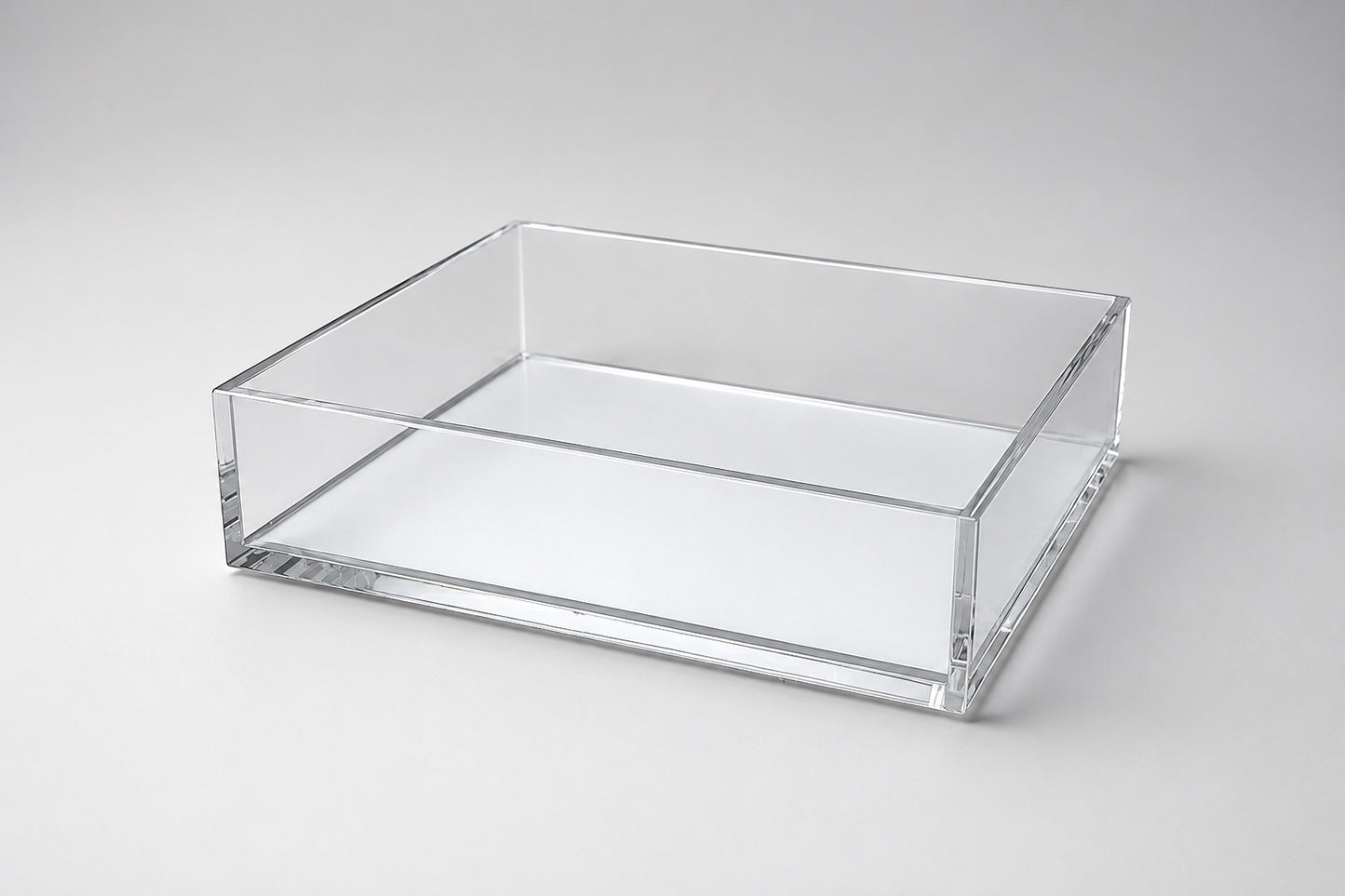Eclectic clear acrylic rectangular display tray with a mirrored base and polished edges for home decor.