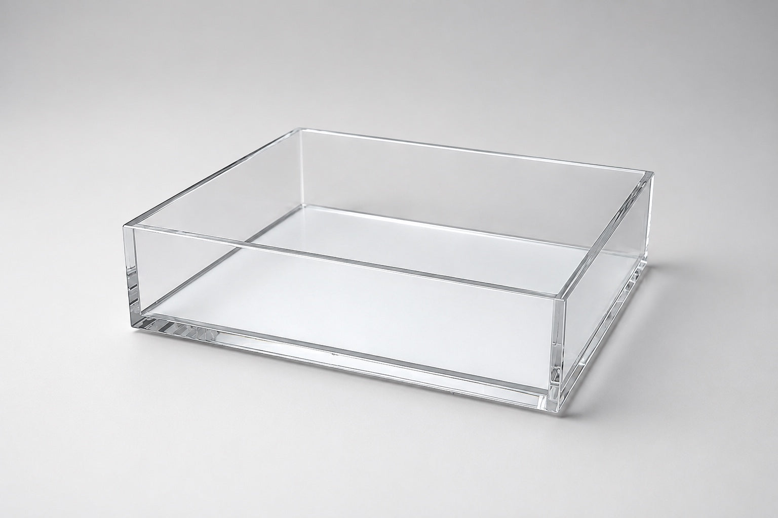 Eclectic clear acrylic rectangular display tray with a mirrored base and polished edges for home decor.