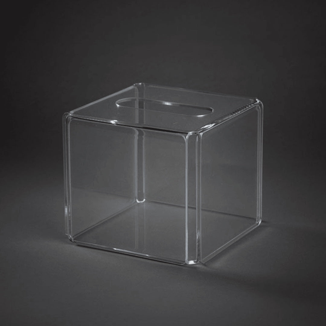 Eclectic clear square acrylic tissue box cover with a minimalist, modern design for vanity or bathroom decor.