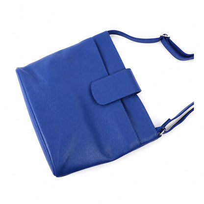 Eclectic Como royal blue pebbled leather crossbody bag with adjustable strap and magnetic flap closure.